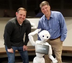 Doug Leidig (Asbury), Tom Mann (Love & Company) and Pepper the Robot. Pepper is one key example of new technology in senior living that can have a huge impact for providers.