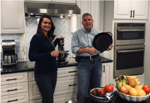 A person standing in a kitchen preparing food
Description automatically generated