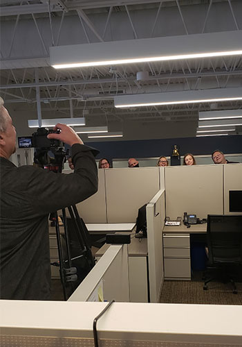 Erik filming the Love & Company team in the office.